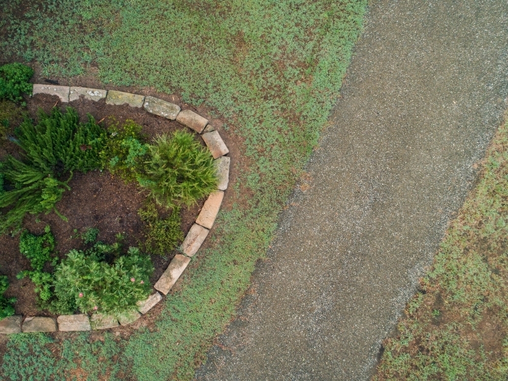 Driveway beside garden with sandstone block edging - Australian Stock Image