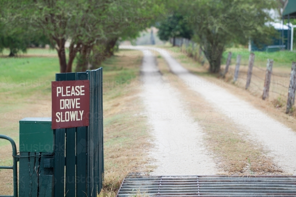 Driveway with a Please Drive Slowly sign - Australian Stock Image