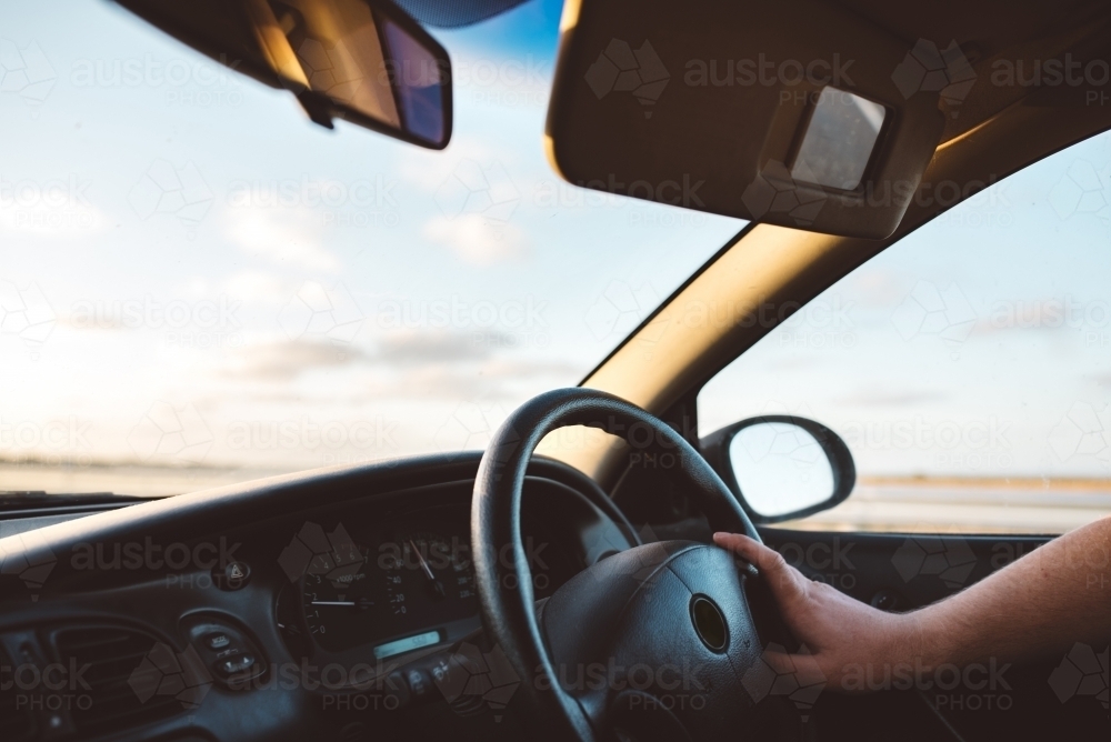 Driving a car into the sunset - Australian Stock Image