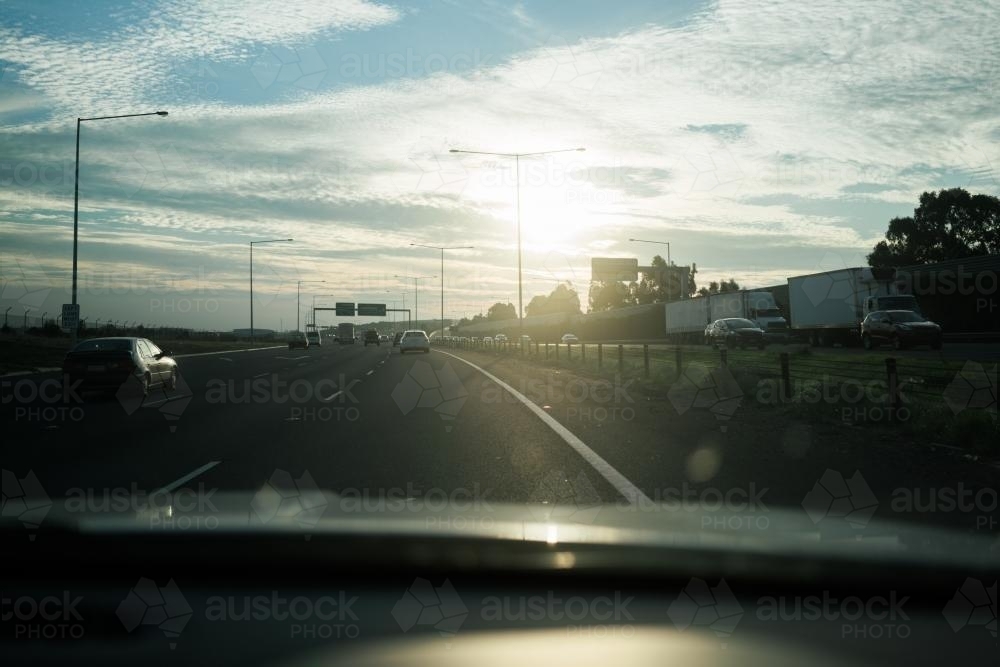 Driving into the Sun on Western Ring Road, Victoria - Australian Stock Image