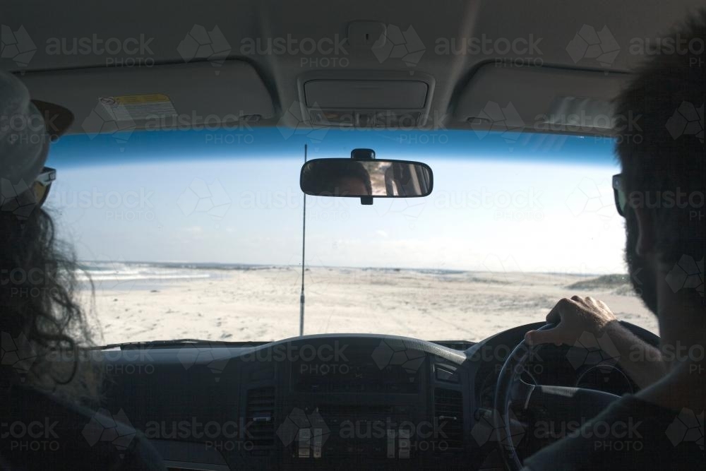 Driving on beach in 4WD to find surf - Australian Stock Image