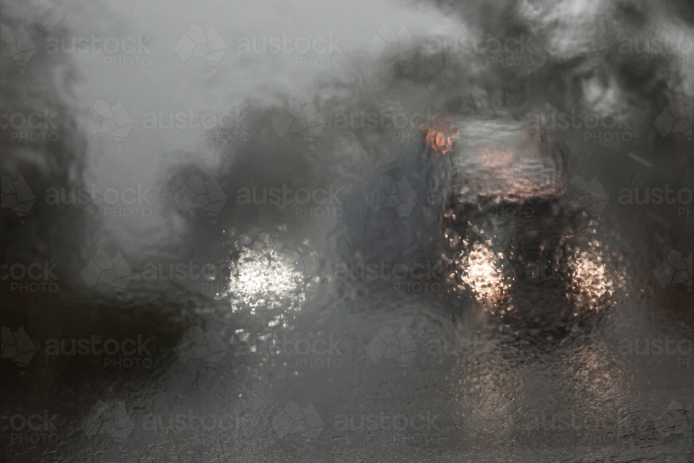 driving through heavy rain with passing trucks and cars - Australian Stock Image