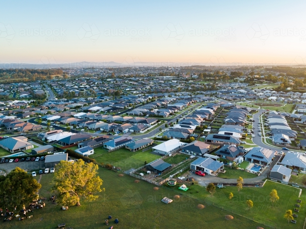 Drone image of last light of the day over suburb of Aberglasslyn in Hunter Valley showing houses - Australian Stock Image