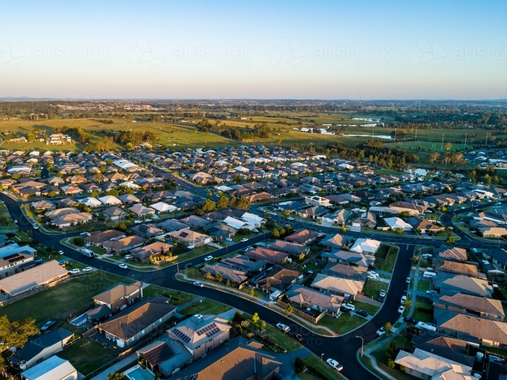Drone image of last light of the day over suburb of Aberglasslyn in Hunter Valley showing houses - Australian Stock Image