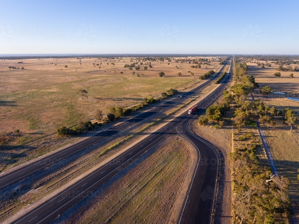 dual carriageway cutting through farmland with exit to parking bay - Australian Stock Image