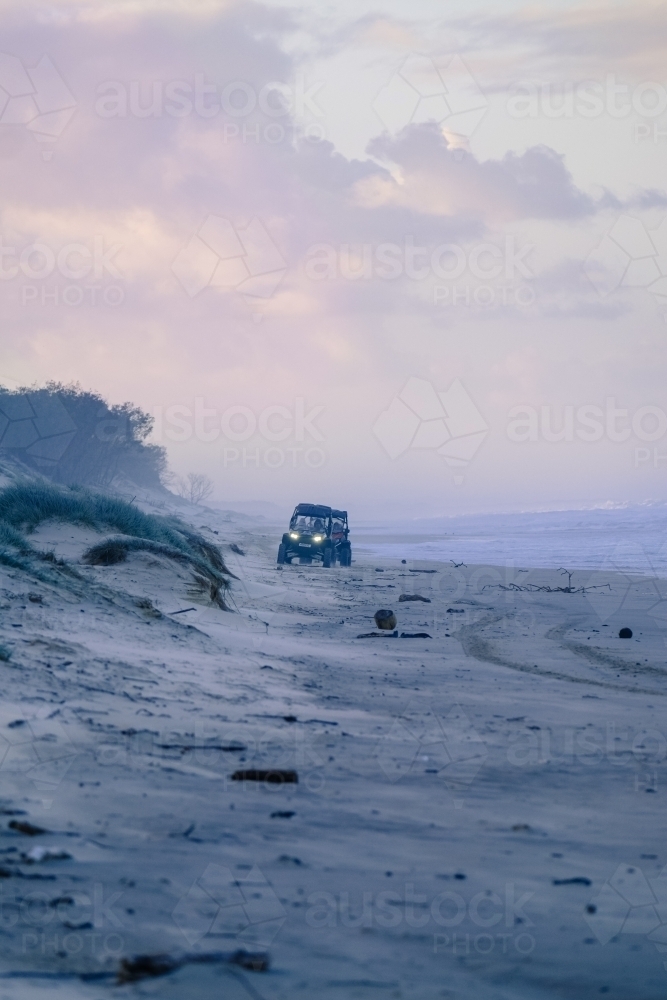 Dune buggies on South Stradbroke Island at dusk - Australian Stock Image