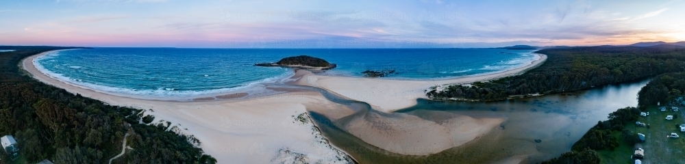 Dusk light over coastal bay and river mouth with crampton island in the distance - Australian Stock Image