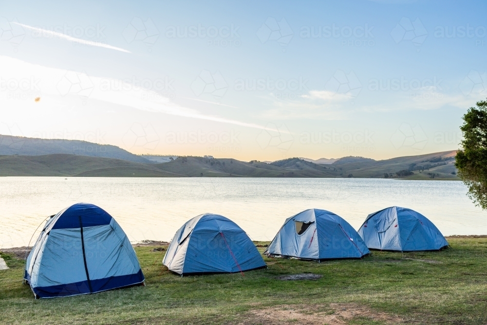 Dusk light over tents at lakeside campground  - Australian Stock Image