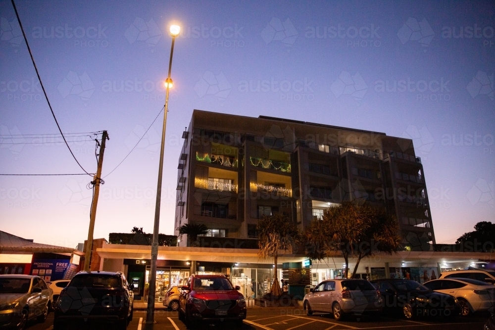 dusk photo of retail strip and unit block decorated with Christmas Lights - Australian Stock Image