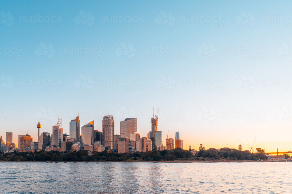 dusk Sydney city skyline at sunset viewed from Royal Botanic Garden. - Australian Stock Image