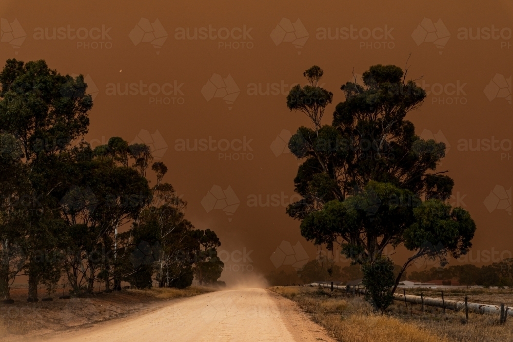dust storm blowing in over dirt road - Australian Stock Image