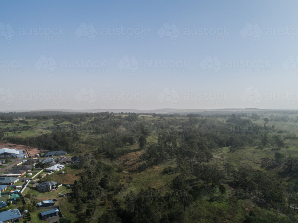 Dust storm haze on horizon over Australian landscape at edge of town - Australian Stock Image