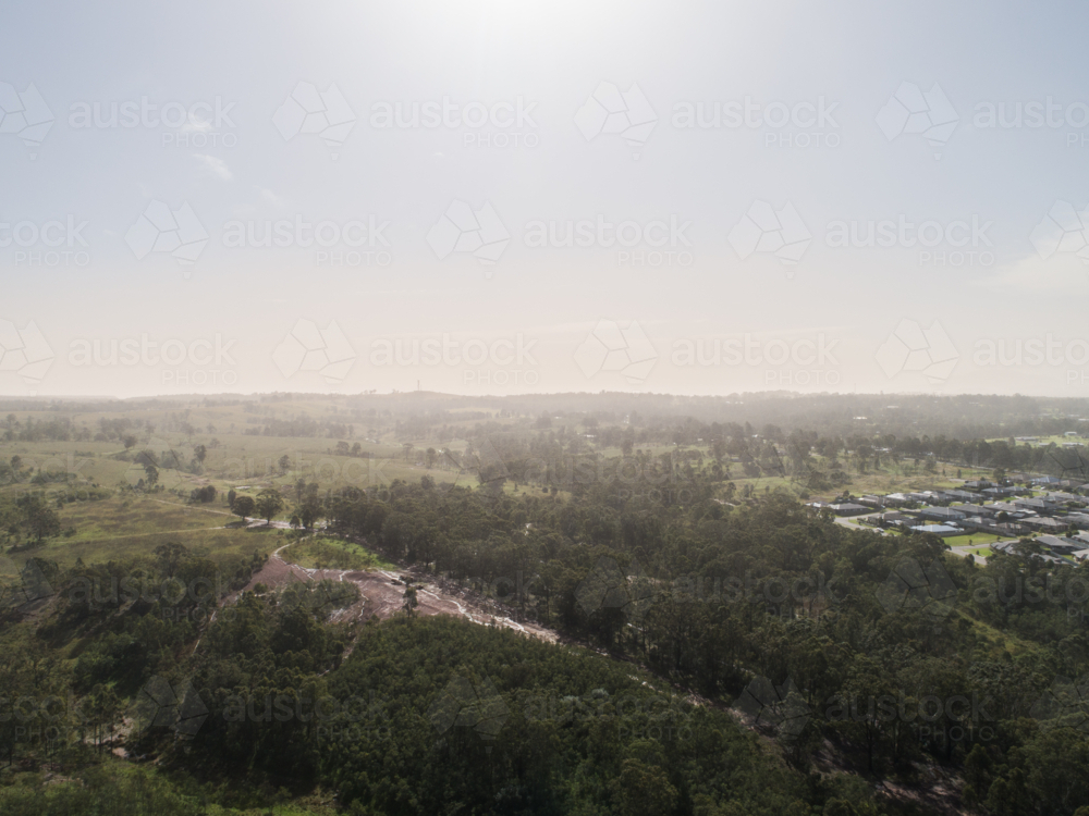 Dust storm haze on horizon over Australian landscape at edge of town - Australian Stock Image