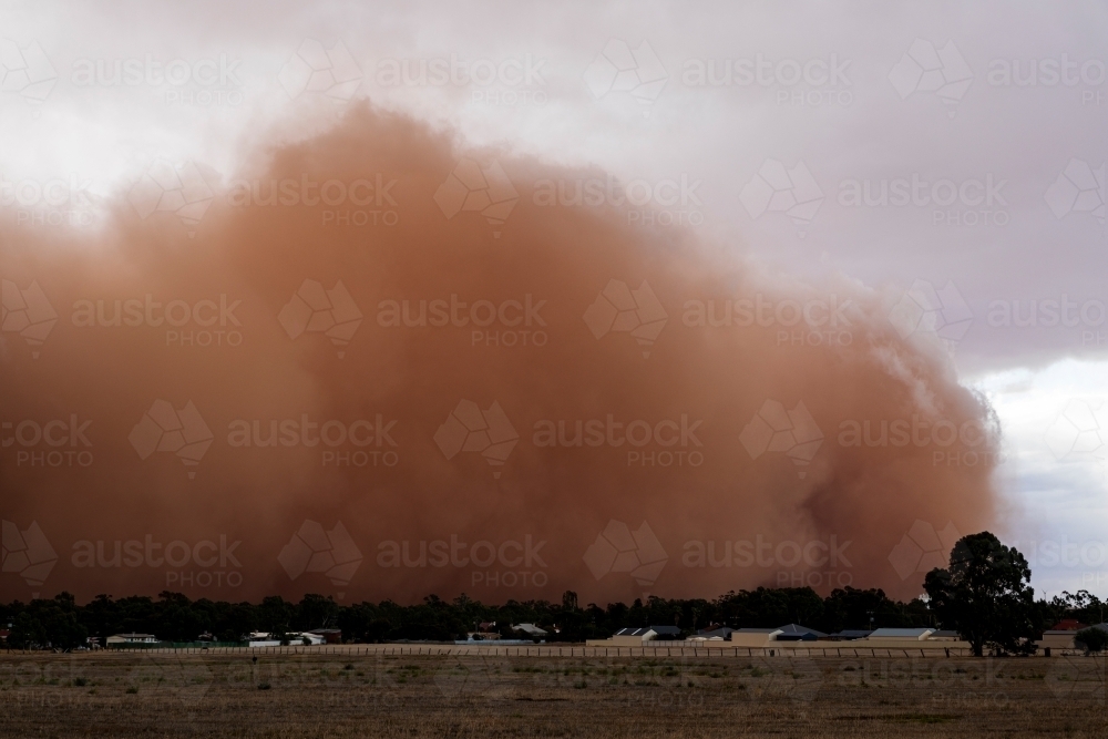 dust storm rolling in over small town - Australian Stock Image