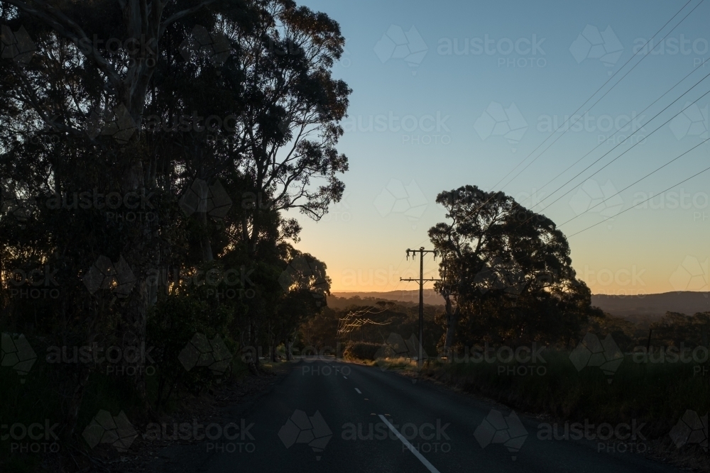 Early morning country scene, road with powerlines - Australian Stock Image