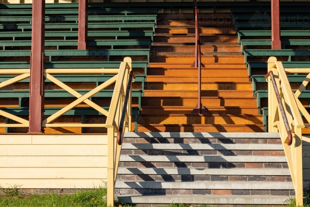 Early morning shadows cast on stairs of empty showgrounds grandstand - Australian Stock Image