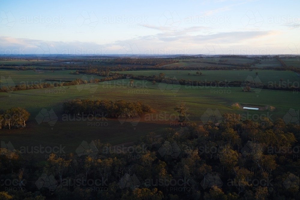 Early morning sunlight on paddocks and the landscape of a Western Australian farm. - Australian Stock Image