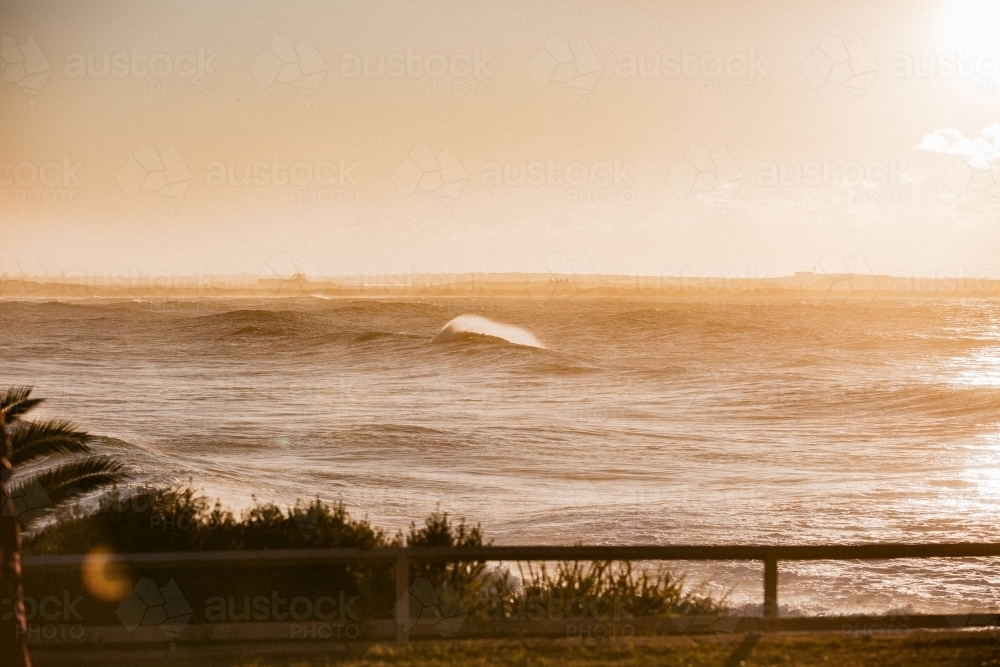 Early morning waves breaking with sea spray - Australian Stock Image