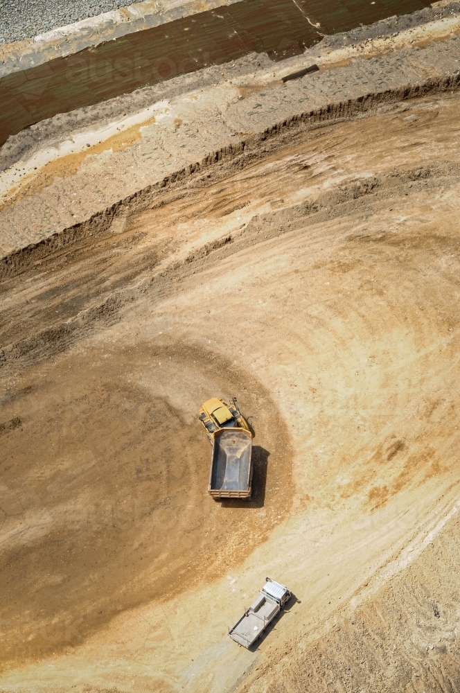 Earth moving equipment doing earth work on industrial construction site - Australian Stock Image