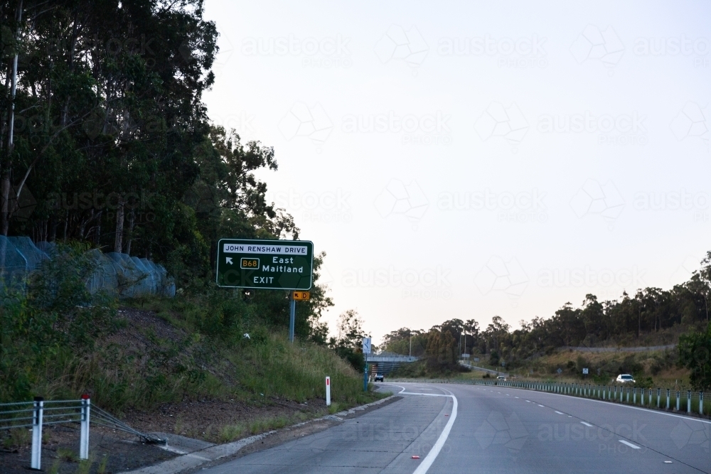 East Maitland exit off highway sign at dusk along Hunter expressway M15 - Australian Stock Image