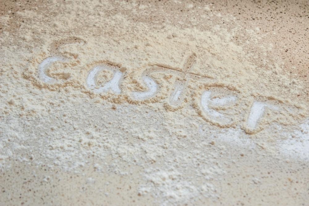 Easter written in flour on the kitchen bench - Australian Stock Image