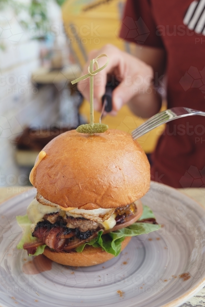 Eating healthy beef burger - Australian Stock Image