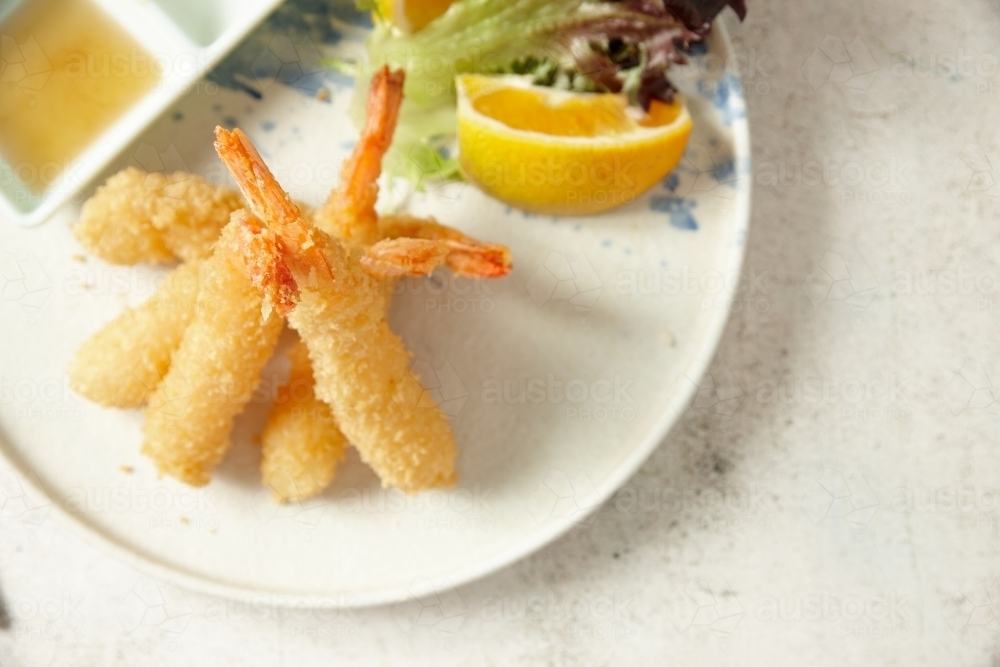 ebi tempura with lemon on a white plate - Australian Stock Image