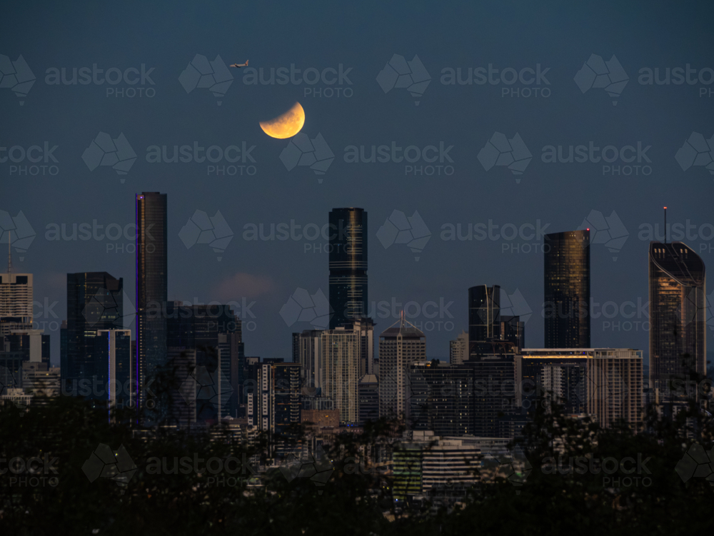 Eclipse of the full moon shining over city skyline in March 2025 - Australian Stock Image
