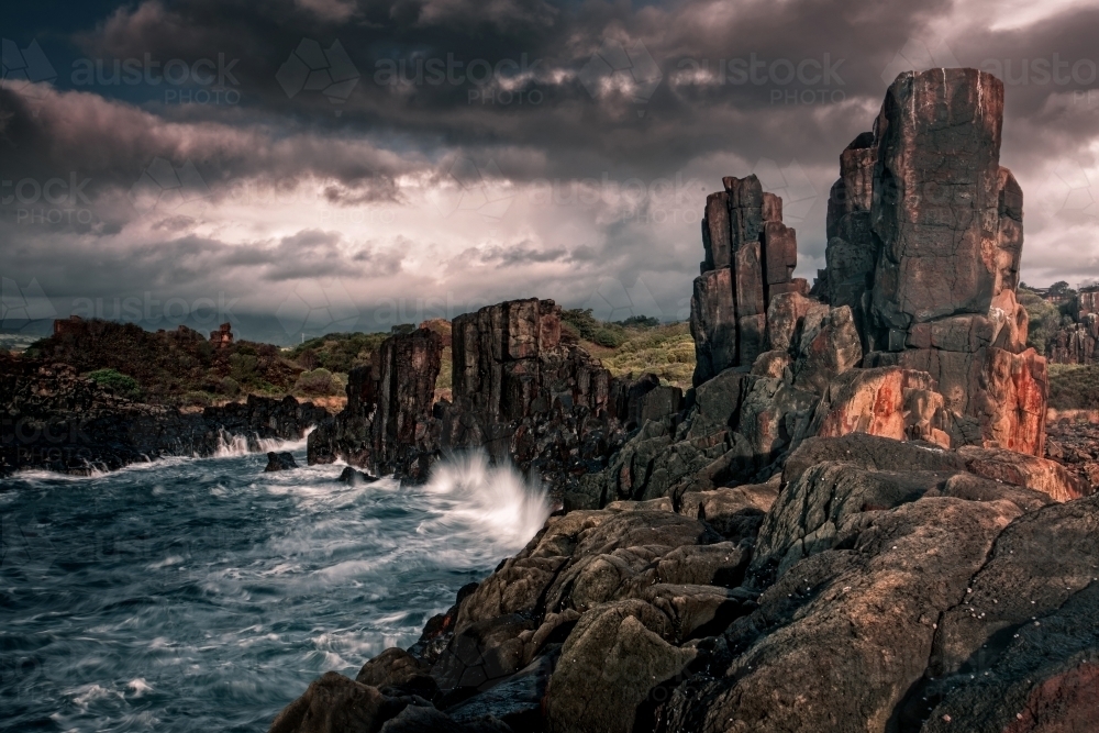 Eerie beauty of the tall imposing Bombo basalt columns - Australian Stock Image