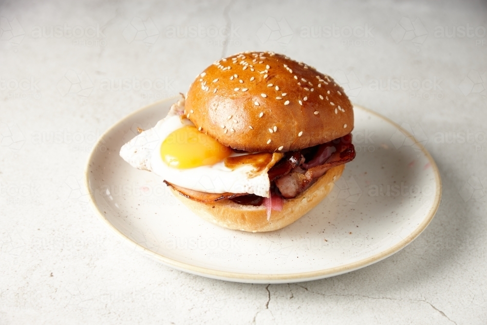 Egg and bacon roll on plate - Australian Stock Image
