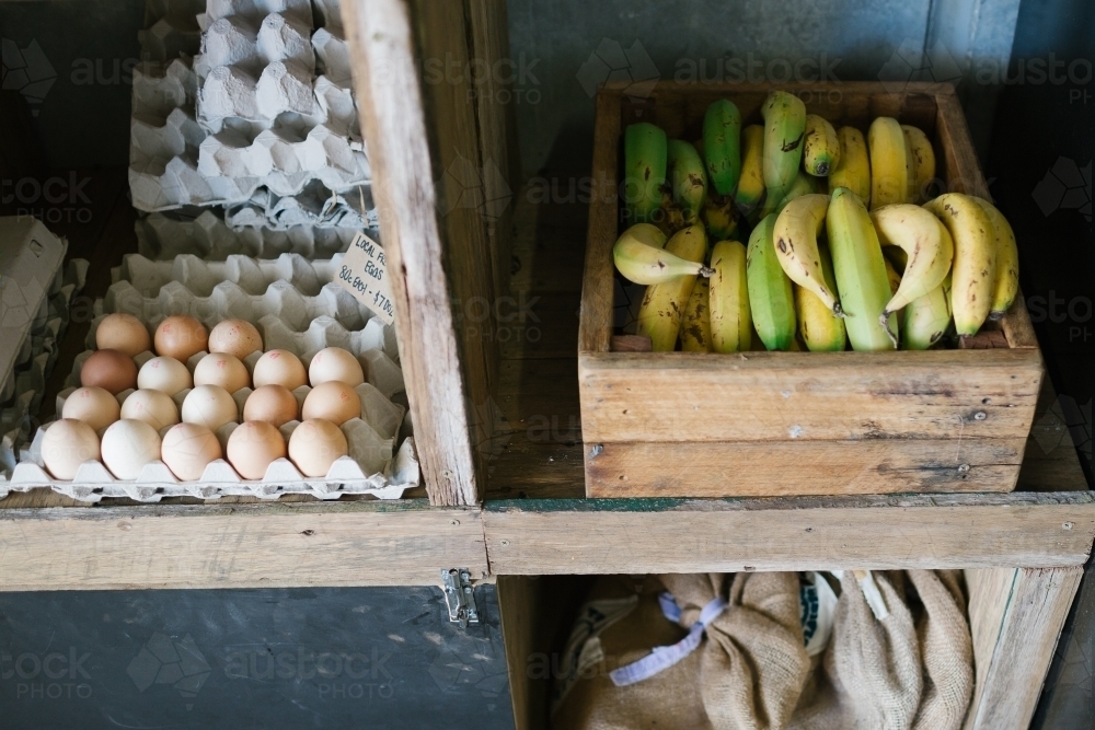 Eggs and Bananas in rustic store shelves - Australian Stock Image