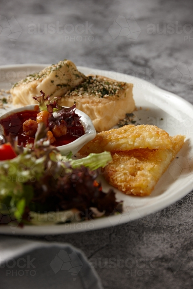 Eggs and hashbrowns with salad - Australian Stock Image
