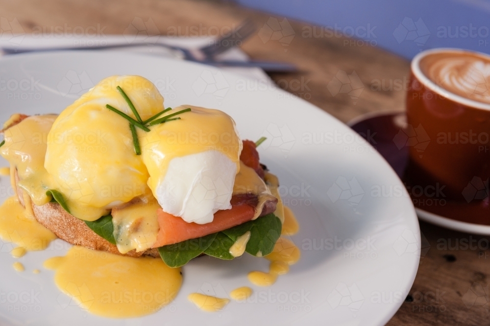 Eggs benedict with salmon, and a flat white - Australian Stock Image