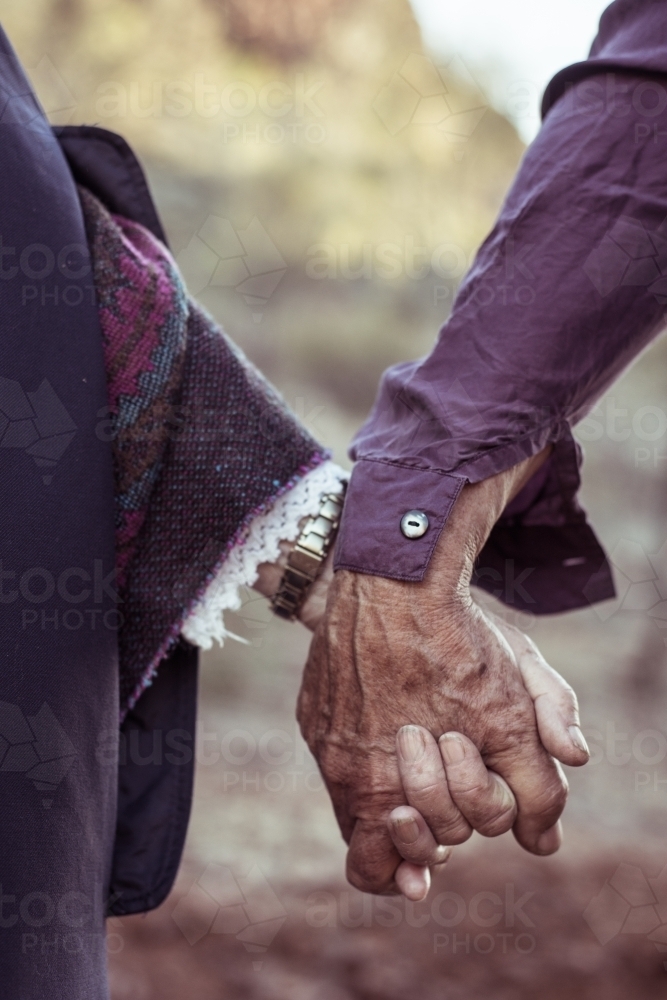 Elderly couple holding hands - Australian Stock Image