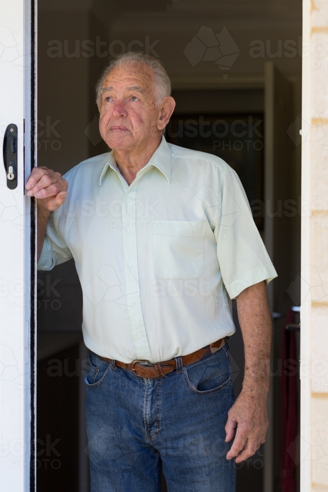 Elderly gentleman in doorway, looking up - Australian Stock Image