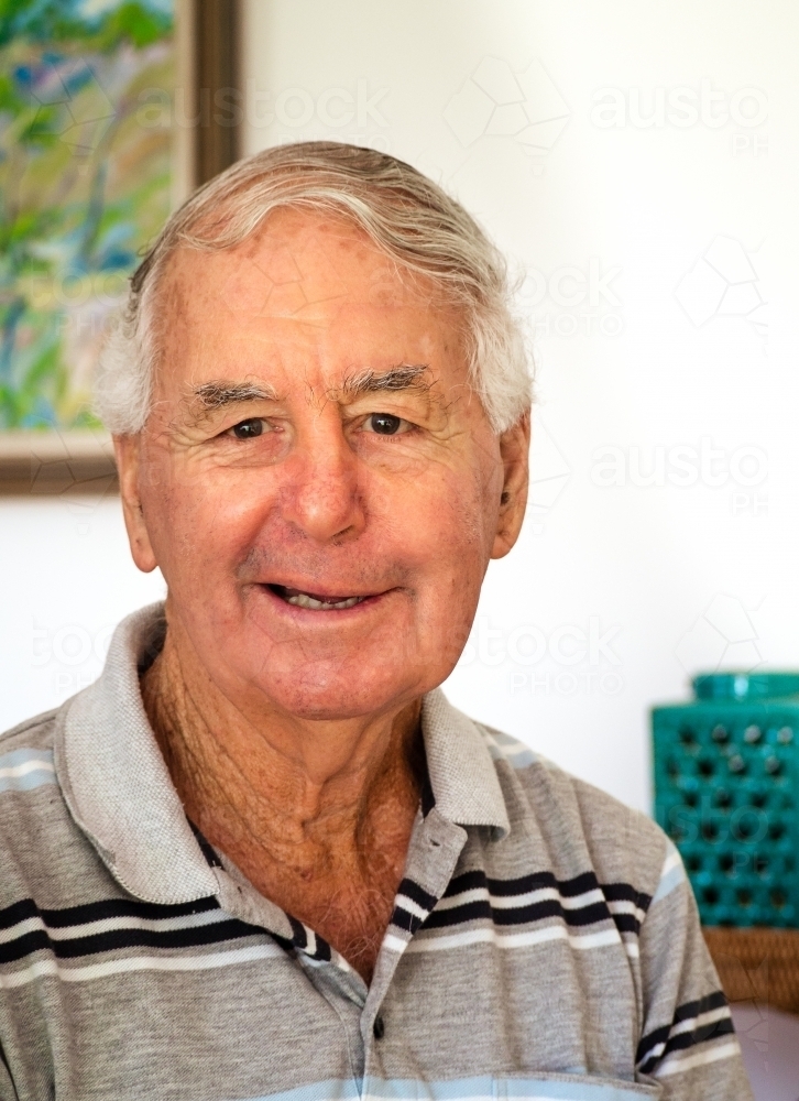 Elderly male smiles at the camera - Australian Stock Image