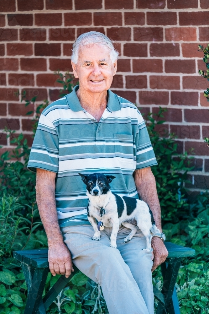 Elderly man and his little dog. - Australian Stock Image
