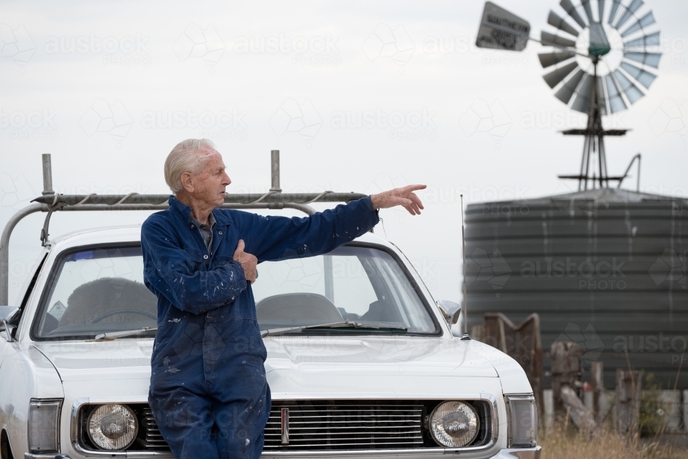 Elderly man pointing at something. - Australian Stock Image