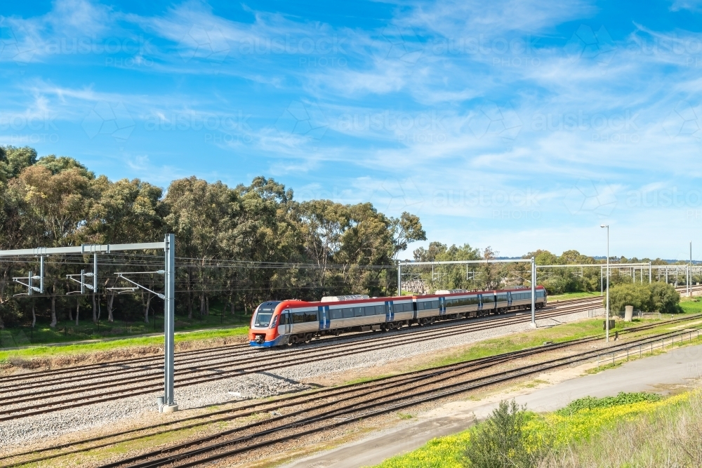 Electric passenger train departing from the Mile End Railway Station and heading to Adelaide city - Australian Stock Image