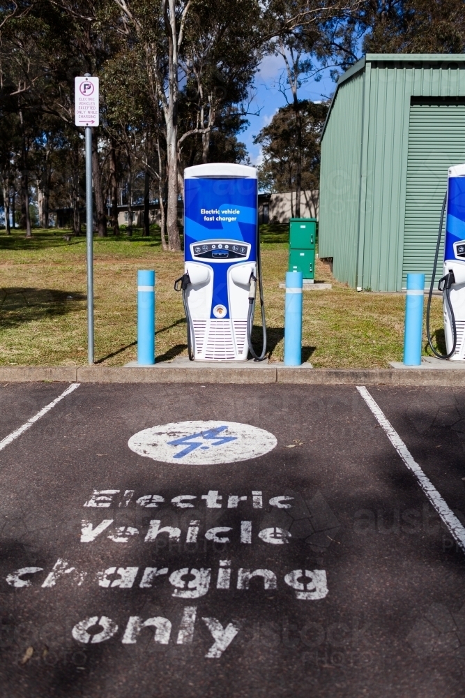 Image of Electric vehicle charging only sign in carpark EV power plug