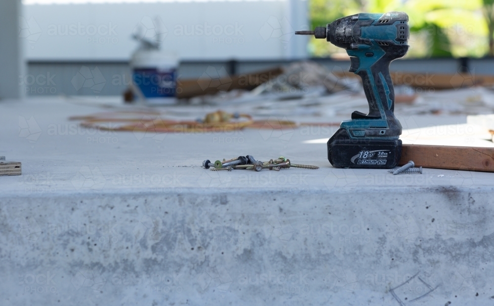 Electrical drill and screws on a building site - Australian Stock Image