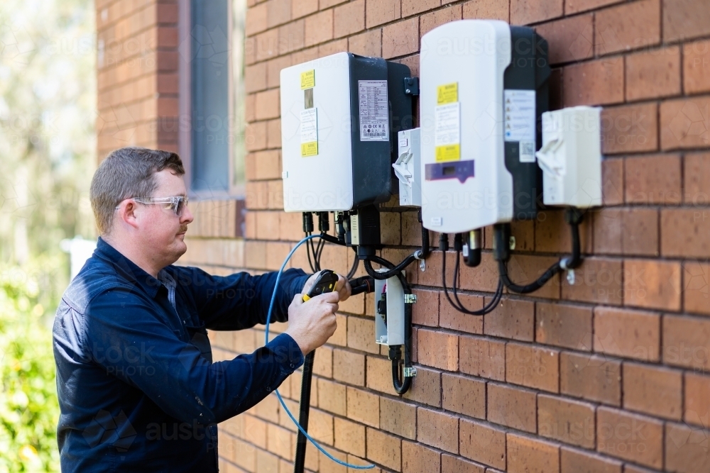 Image of Electrician installing solar power connection to house ...