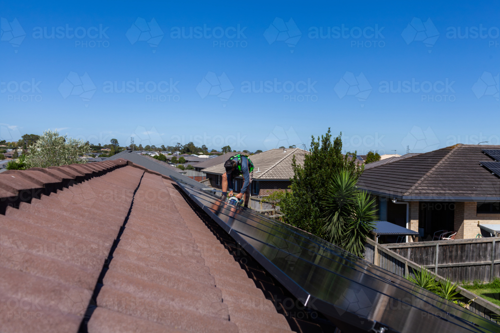 Image of Electrician tradie finishing off solar panel installation on ...