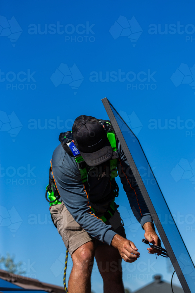 Image of Electrician tradie man connecting bifacial solar panels ...