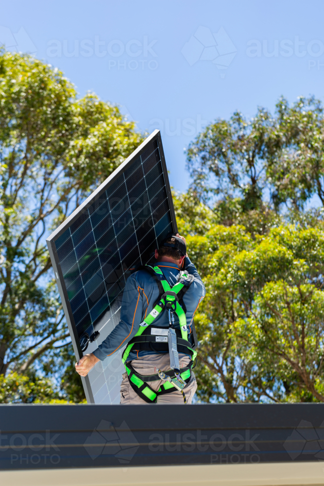 Image of Electrician tradie worker man on roof of house installing ...