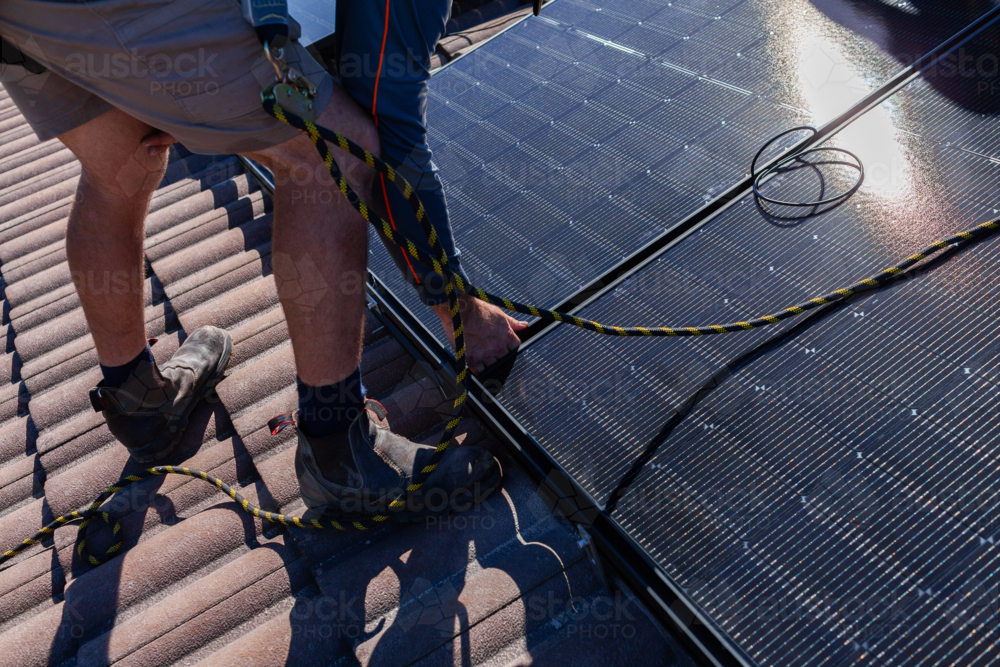 Image of Electrician tradie working on solar panel installation ...