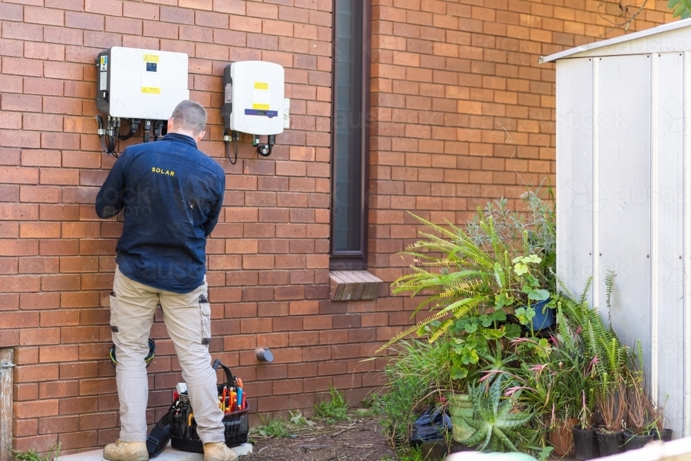 Image of Electrician working on installing a solar power board ...
