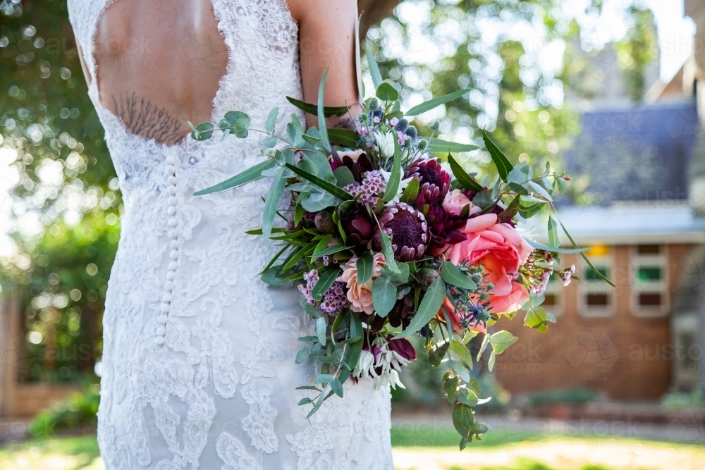 Elegant bride holding bouquet of native australian flowers - Australian Stock Image