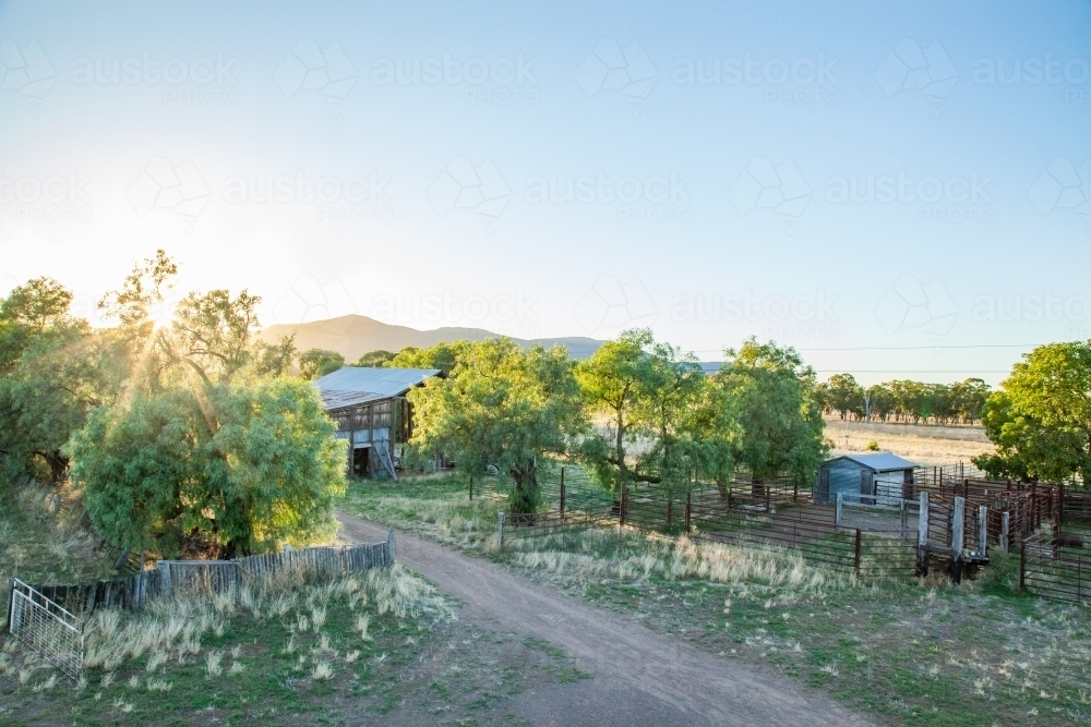 Image of Elevated view of the sun rising over a farm landscape ...