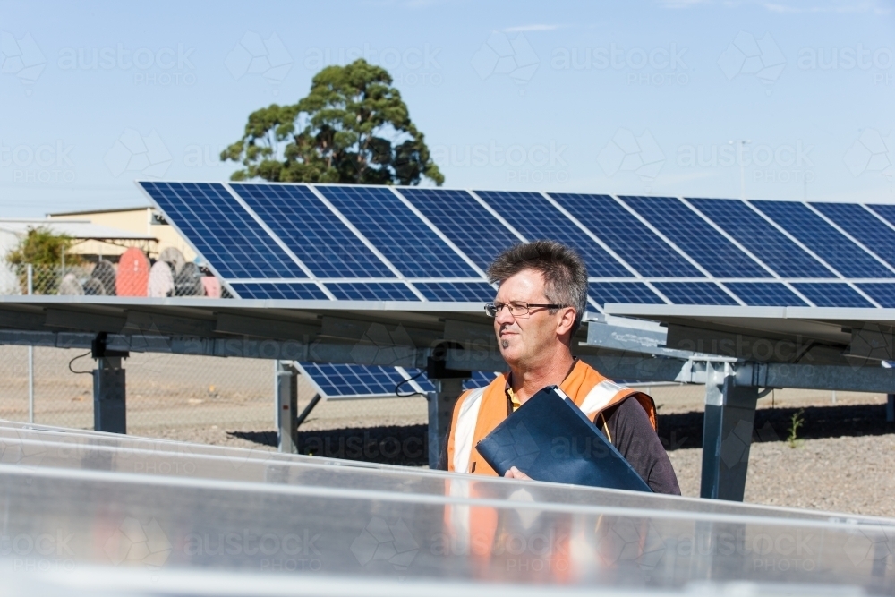 Employee looking over panels at a Solar Panel plant - Australian Stock Image